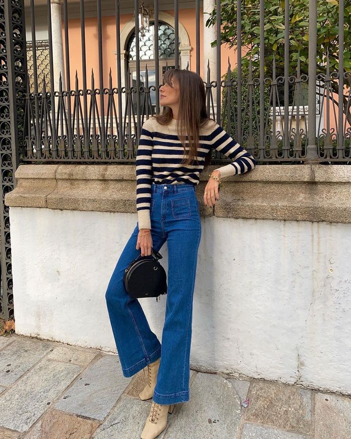Flared jeans with metallic sandals and bow blouse