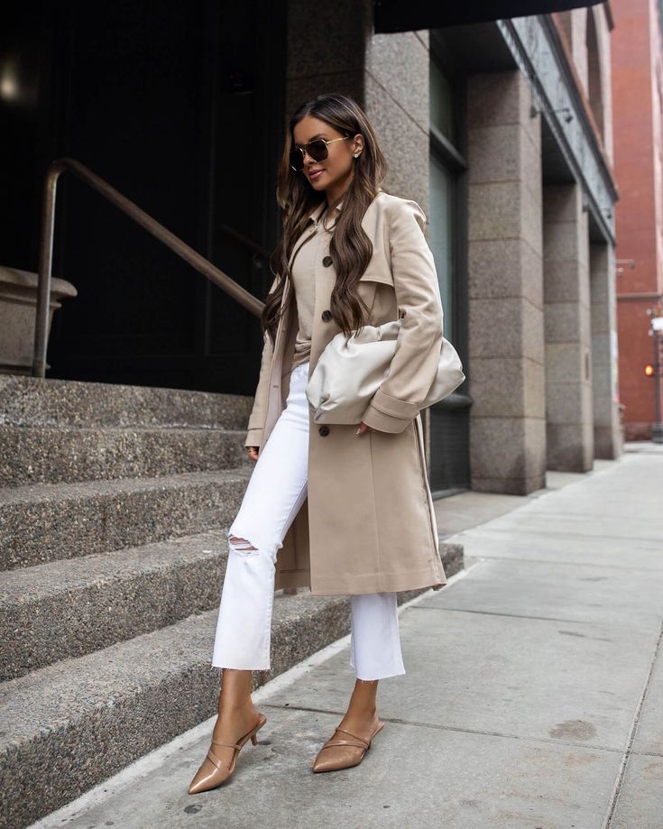 With a trench coat and pointed shoes